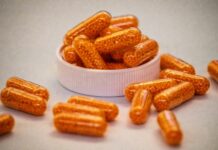 나에게 맞는 영양제, 어떻게 고를까?—최근 트렌드와 실생활 팁 Orange capsules filled with small beads spill from container.