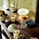 내 몸과 마음을 위한 새로운 습관, ‘대체요법’ 실천법 주목 Various tea ceremony utensils arranged on a wooden table.
