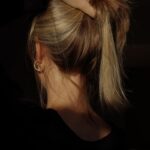 건강한 두피와 윤기나는 머릿결, 일상 속 작은 실천이 비법 a woman with her hair in a bun