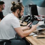 직장인을 위한 거북목·일자목 교정 스트레칭과 실생활 개선법 man holding turned-on iPad in front of turned-off MacBook Air